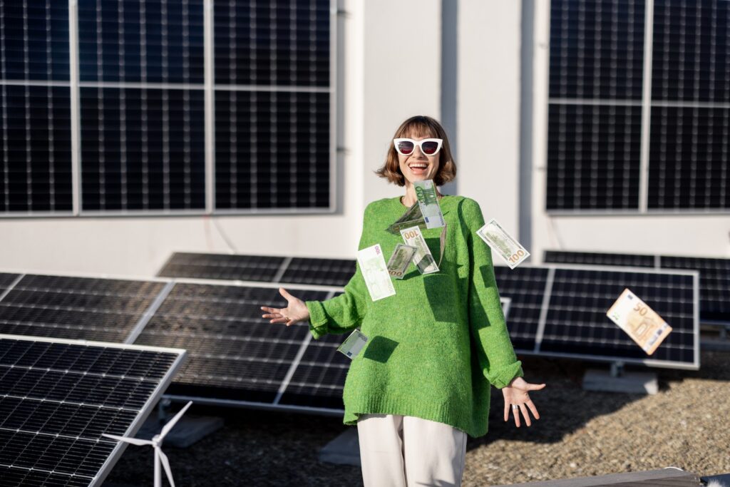 Happy household owner with money near solar power plant